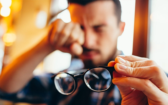 Blurry Man With His Glasses Off Rubbing His Eyes