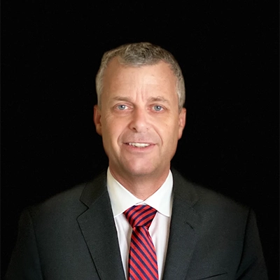 Eye Doctor Douglas Wike Smiling In A Suit